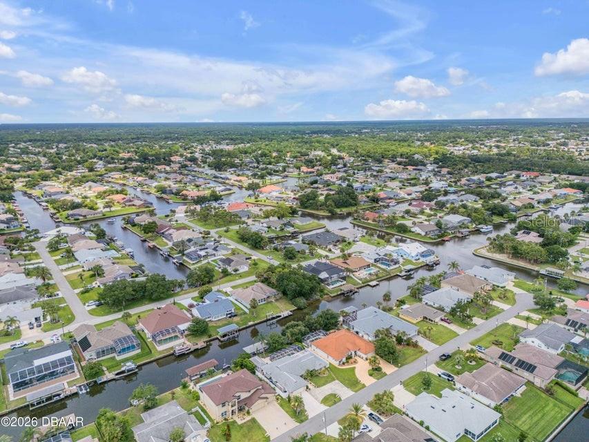 An aerial view shows a residential neighborhood with houses situated along a network of canals — 9 N CHRISTOPHER COURT, PALM COAST, FL