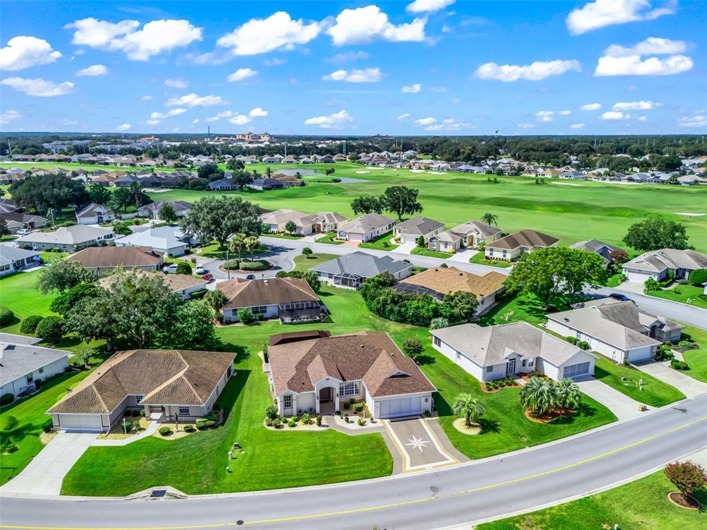 An aerial view of a suburban neighborhood featuring single-family homes and a golf course — 11768 SE 176TH PLACE ROAD, SUMMERFIELD, FL