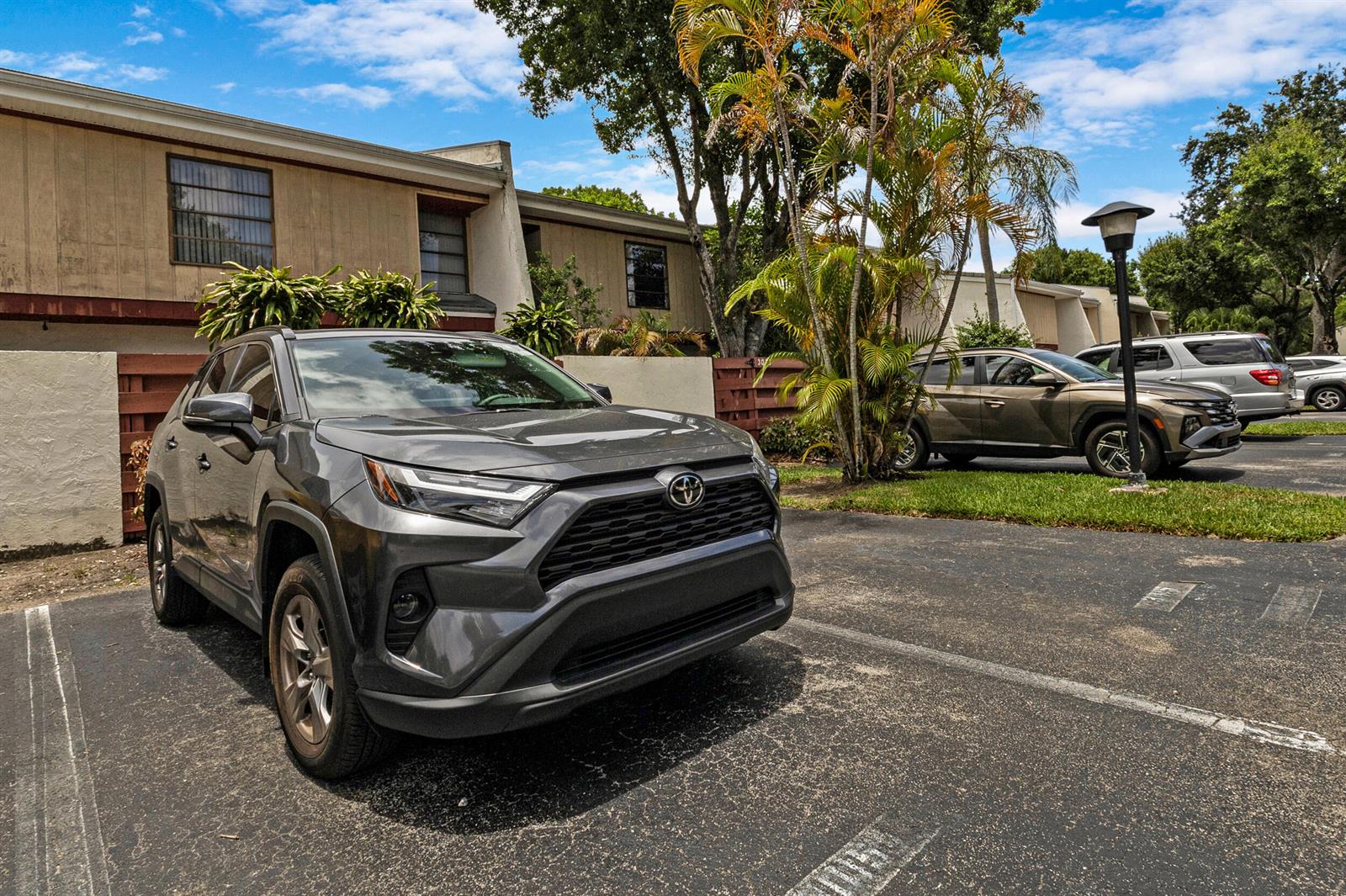 A gray Toyota RAV4 is parked in a paved lot in front of a building — 3015 Oaktree Lane Unit 277, Hollywood FL 33021, HOLLYWOOD, FL
