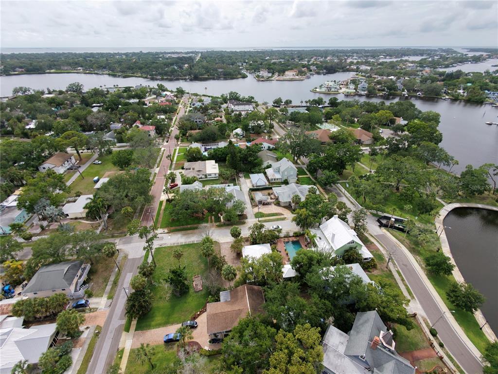 An aerial view shows a residential neighborhood with houses, trees, and a nearby waterway — 0 W LEMON STREET, TARPON SPRINGS, FL