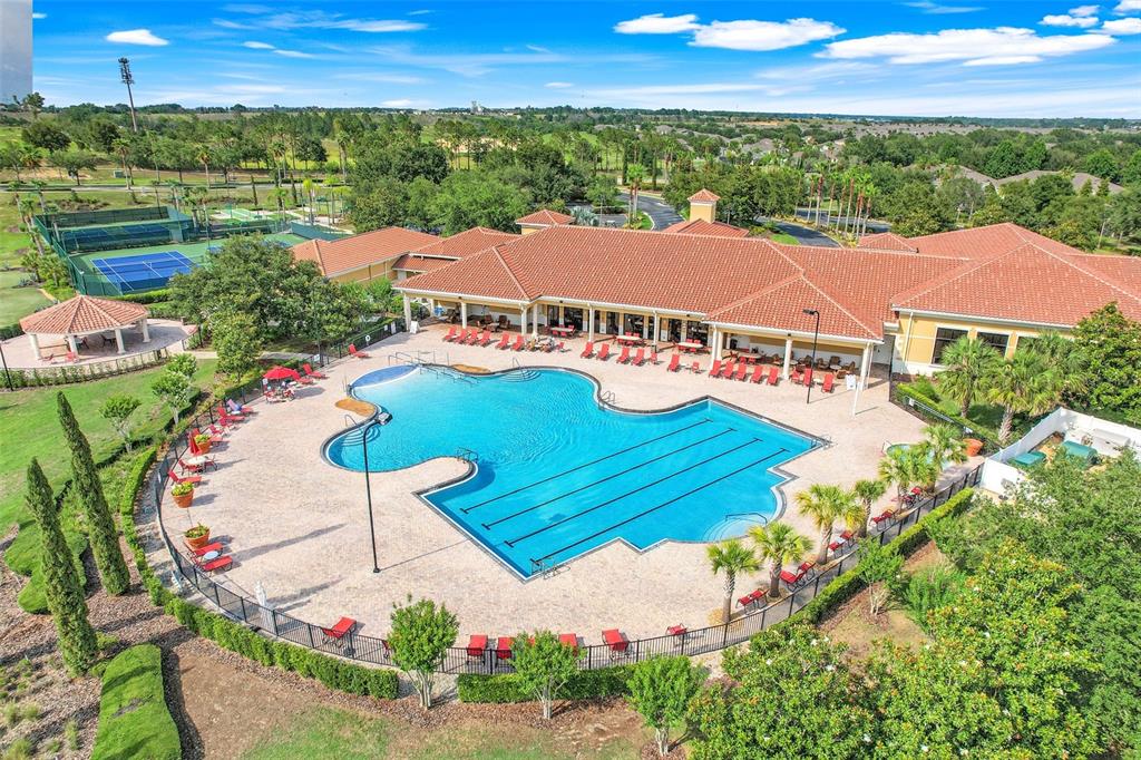 An aerial view of a community clubhouse with a swimming pool and tennis courts — 3550 FAIRWATERS COURT UNIT D, CLERMONT, FL