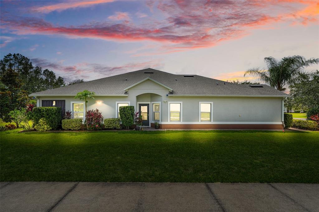 A single-story house with a light-colored exterior, a gabled roof, and a green lawn — 3550 FAIRWATERS COURT UNIT D, CLERMONT, FL