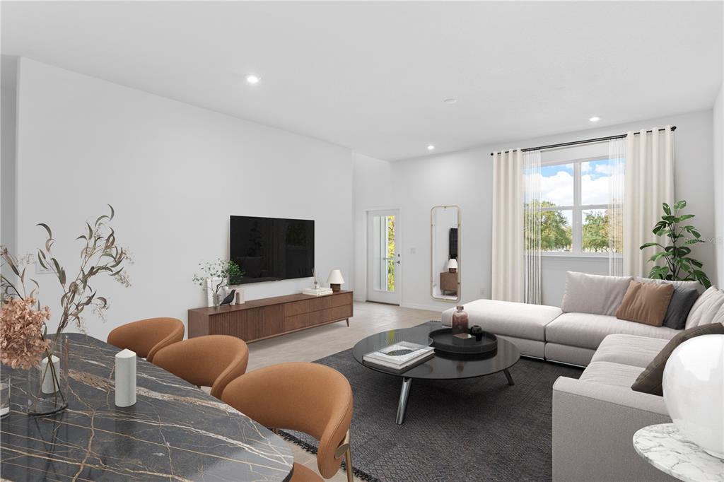 A modern living and dining area features a sectional sofa, television, and marble-topped dining table — 9608 MONTAGUE STREET, WESTCHASE, FL