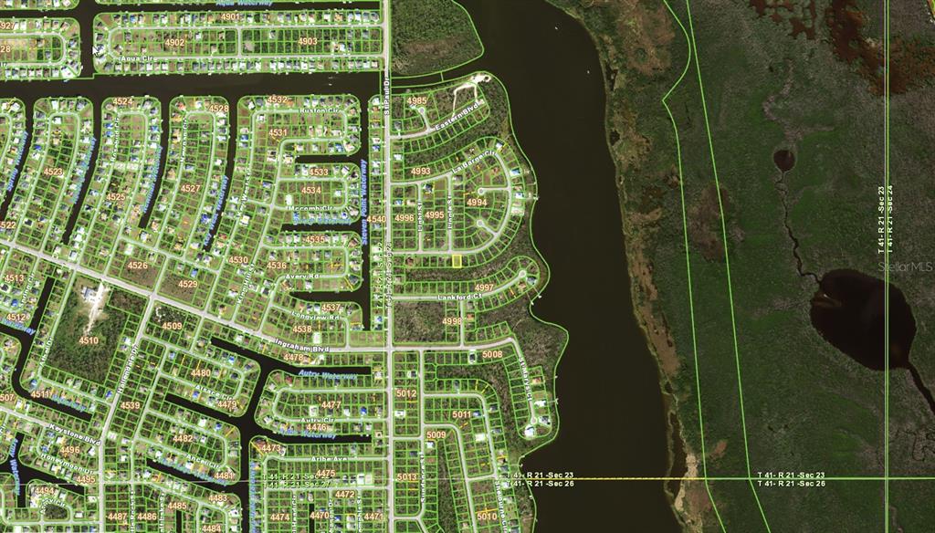 This is a satellite map showing a residential neighborhood with canals and adjacent undeveloped land — 16280 LA BARGE CIRCLE, PORT CHARLOTTE, FL