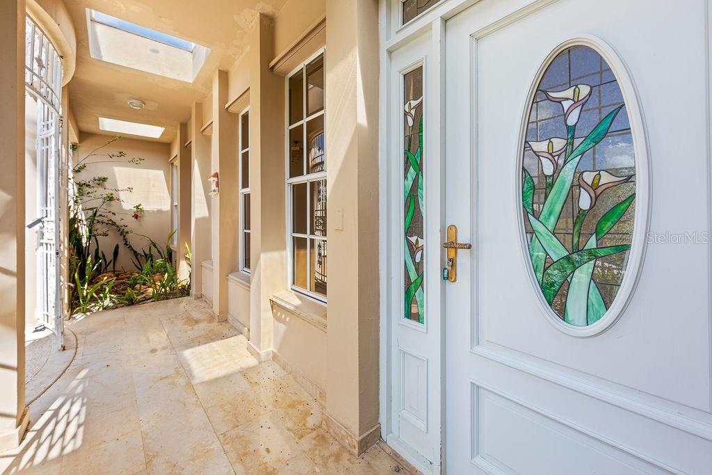 A covered outdoor entryway features a white door with a stained glass calla lily design — URB. SANTA MARIA 1906 CLL ORQUIDEA, SAN JUAN, PR
