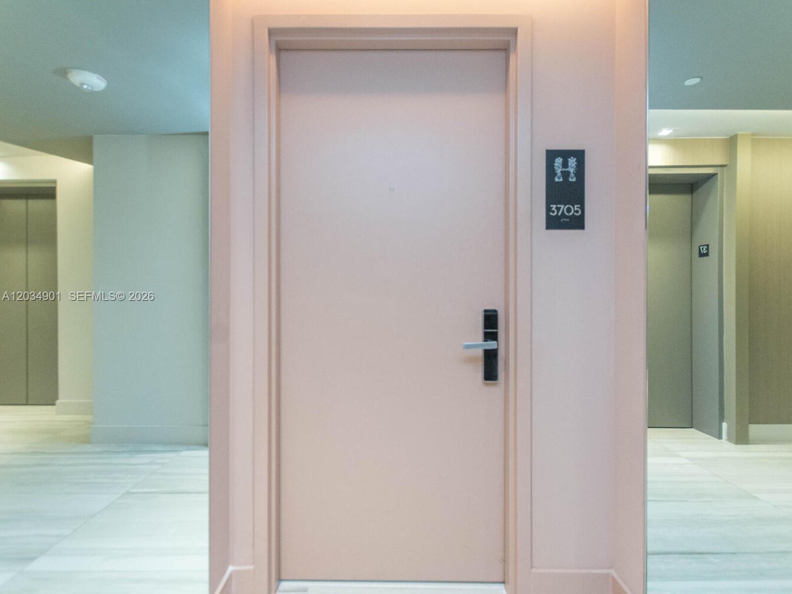 A light-colored apartment door with a digital lock and unit number 3705 in a hallway — 4010 S Ocean Dr # T3705, Hollywood FL 33019, HOLLYWOOD, FL