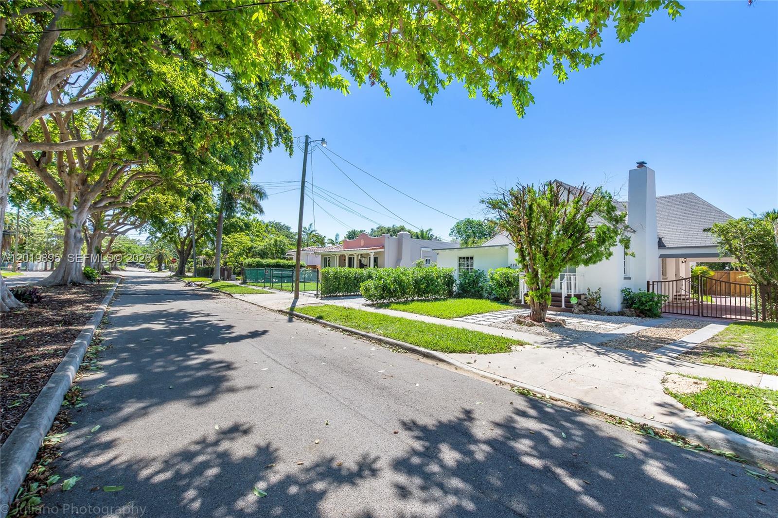 A street view shows a white house with a chimney and large trees nearby — 228 SW 23rd Rd, Miami FL 33129, MIAMI, FL