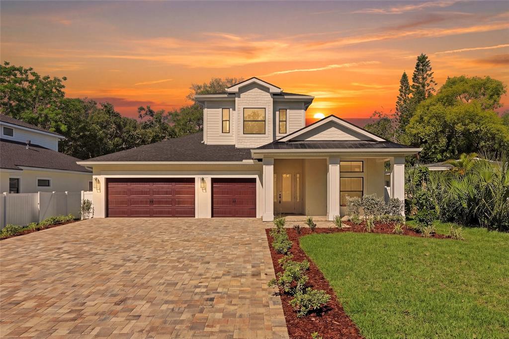 A two-story house with a paved driveway, two-car garage, and a covered front porch — 2376 RAJEL AVENUE, SAFETY HARBOR, FL