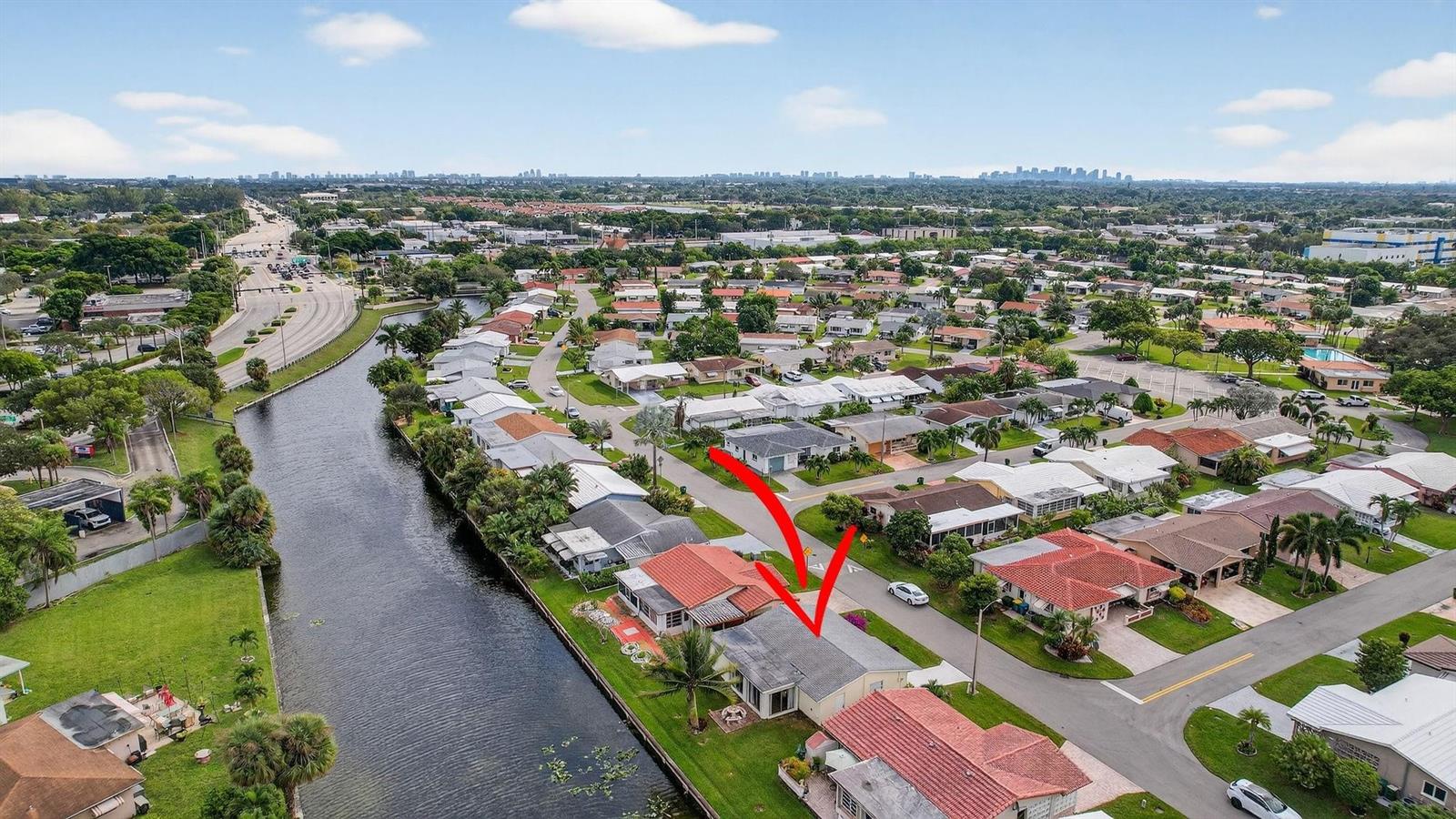 An aerial view shows a residential neighborhood with a canal and a house marked red — 4305 NW 49th Drive, Tamarac FL 33319, TAMARAC, FL