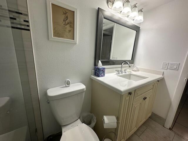 A bathroom features a white vanity, a framed mirror, a toilet, and a glass shower — 2615 NE 3rd Court # 112, Boynton Beach FL 33435, BOYNTON BEACH, FL