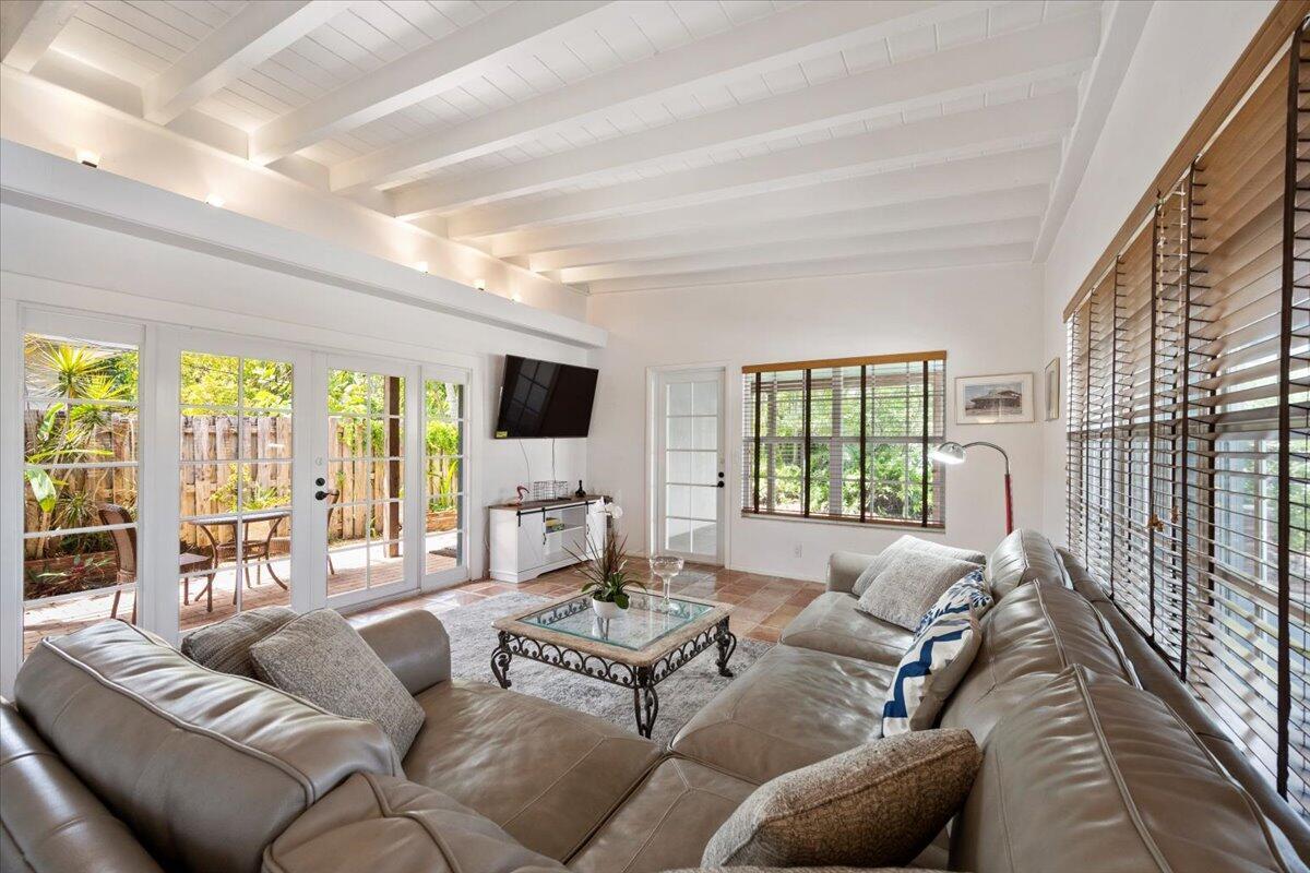 A living room features a vaulted beamed ceiling, tile floors, and a large leather sectional — 2201 N Lakeside Drive, FL 33460, FL