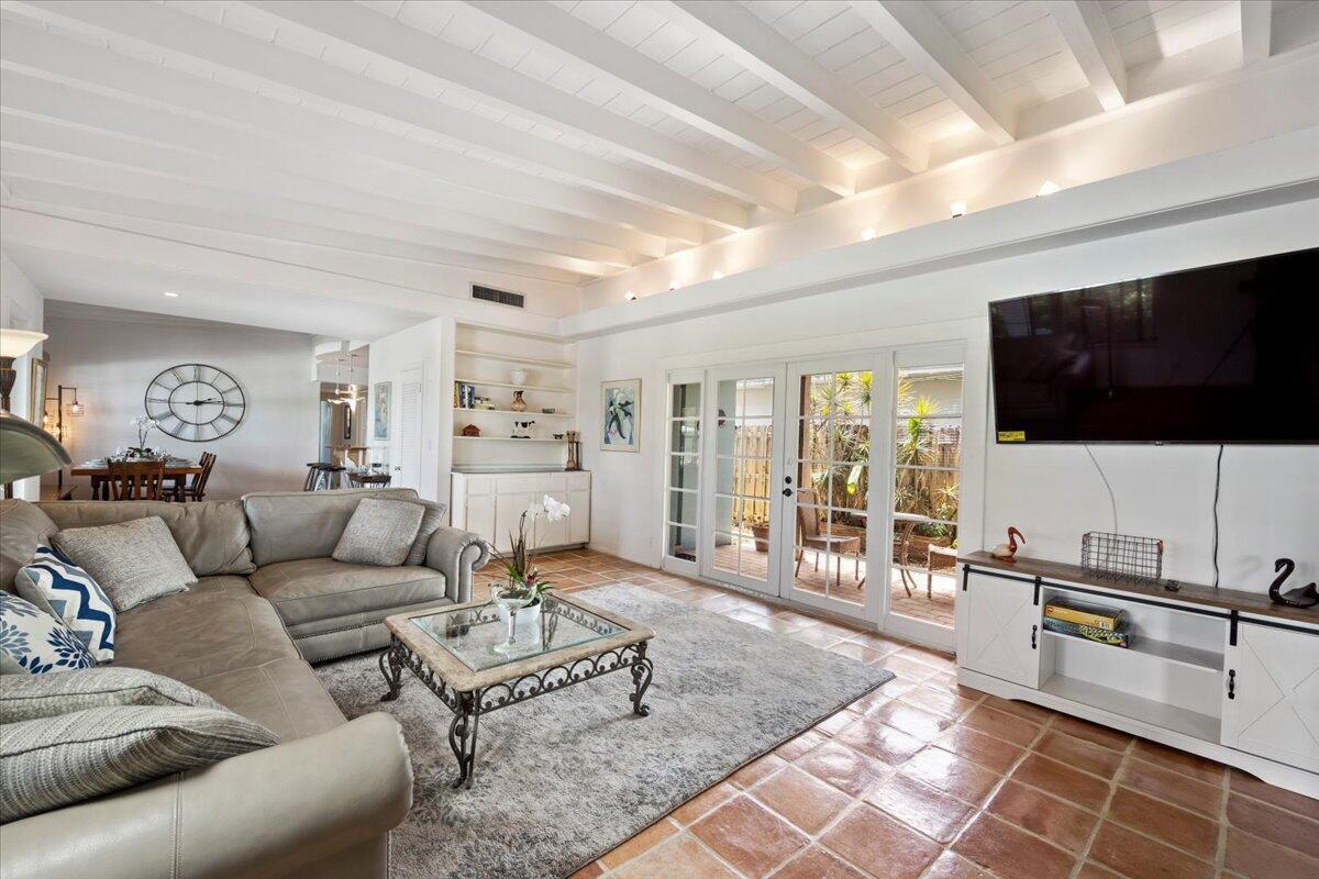 A living room features a sectional sofa, a glass coffee table, and white beamed ceilings — 2201 N Lakeside Drive, FL 33460, FL