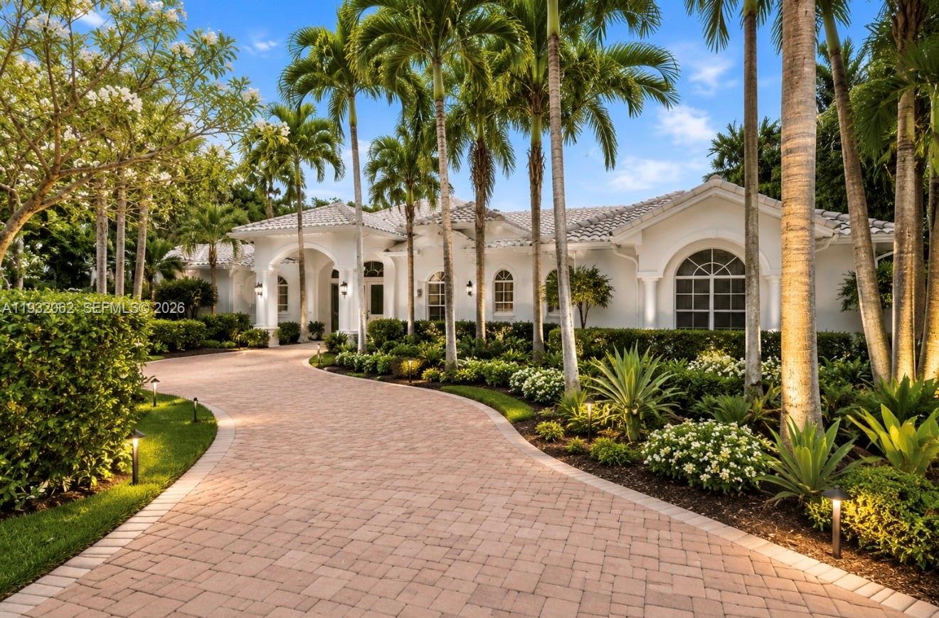 A white single-story house with a paved driveway and palm trees in the front yard — 11825 S Mitchell Manor Cir, Pinecrest FL 33156, PINECREST, FL