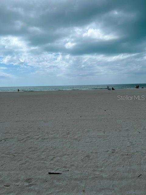 A wide, sandy beach stretches toward the ocean under a cloudy sky — 17920 GULF BOULEVARD UNIT 502, REDINGTON SHORES, FL