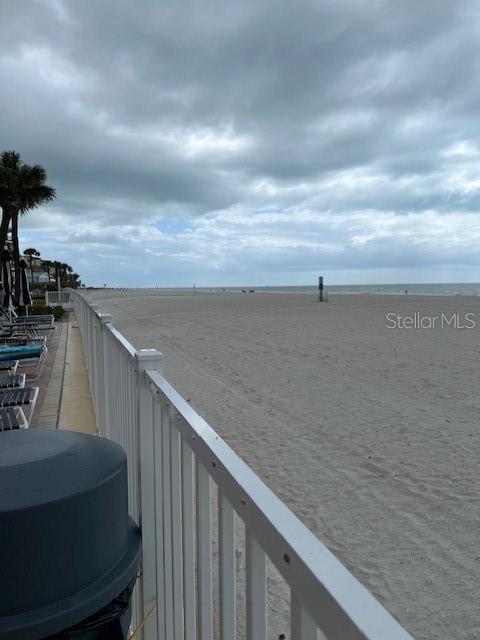 A white fence borders a sandy beach under a cloudy sky — 17920 GULF BOULEVARD UNIT 502, REDINGTON SHORES, FL