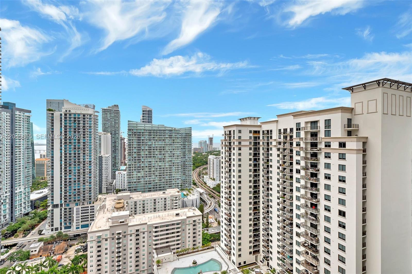 An elevated view of a dense urban skyline featuring multiple high-rise apartment buildings — 55 SW 9th St # 3104, Miami FL 33130, MIAMI, FL