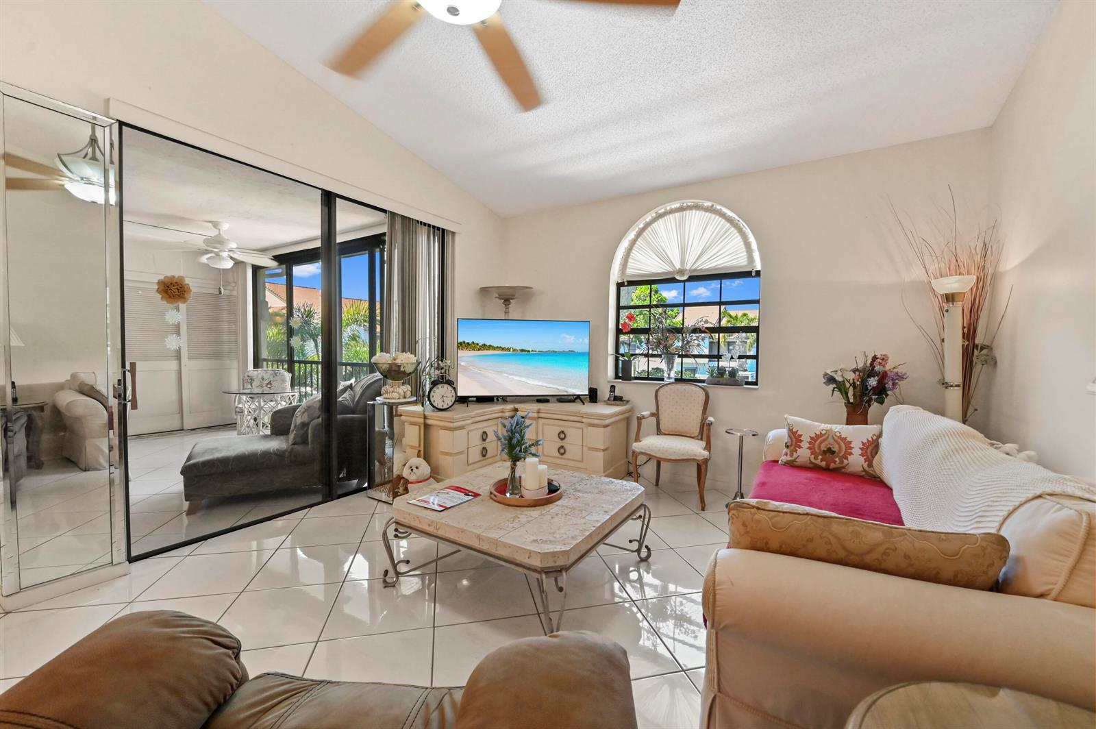 A living room features tile floors, a television on a corner console, and sliding glass doors — 5450 Verona Drive # O, Boynton Beach FL 33437, BOYNTON BEACH, FL