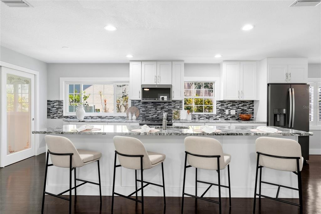 A two-story house with a white picket fence, front porch, and brick walkway at dusk — 2720 10TH STREET N, ST PETERSBURG, FL