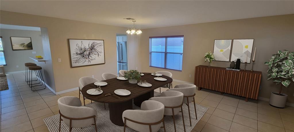A dining room features a dark oval table, six chairs, and a wooden sideboard — 15461 GALBI DRIVE, ORLANDO, FL
