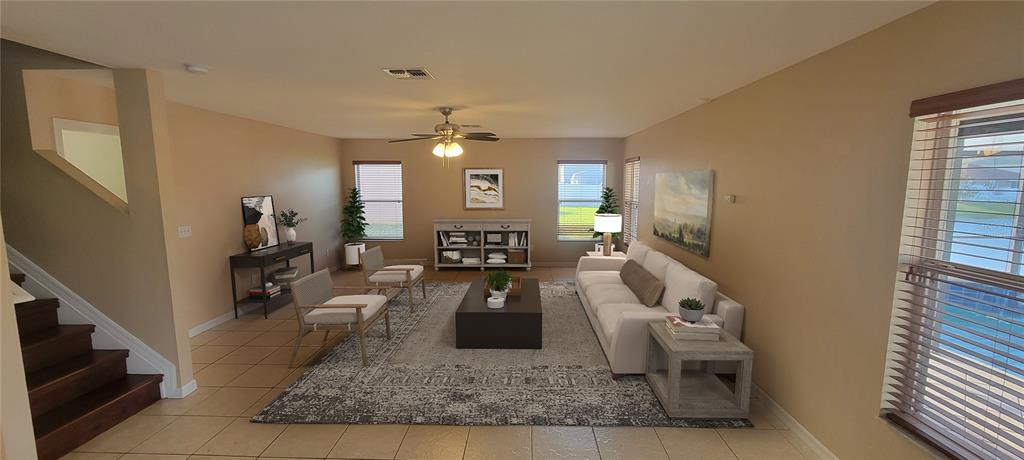 This is a digital rendering of a living room with tile floors and a staircase — 15461 GALBI DRIVE, ORLANDO, FL