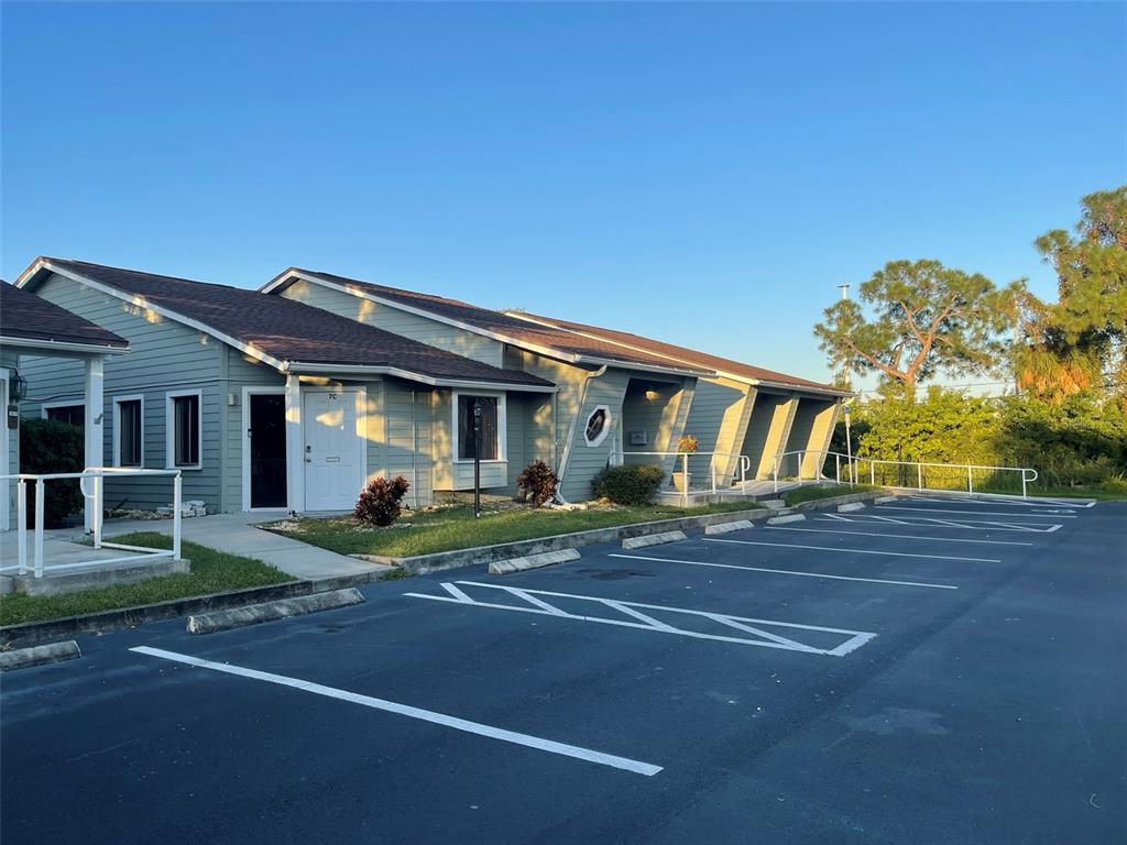 A single-story commercial building with light green siding and a parking lot in front — 10225 ULMERTON ROAD UNIT 7C, LARGO, FL