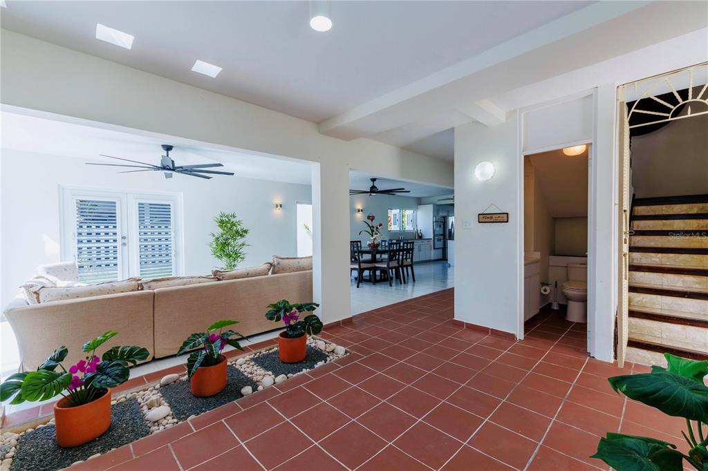A tiled living area features an indoor planter bed, a sofa, and a dining room — 75 FRAGATA UNIT 75, GUANICA, PR