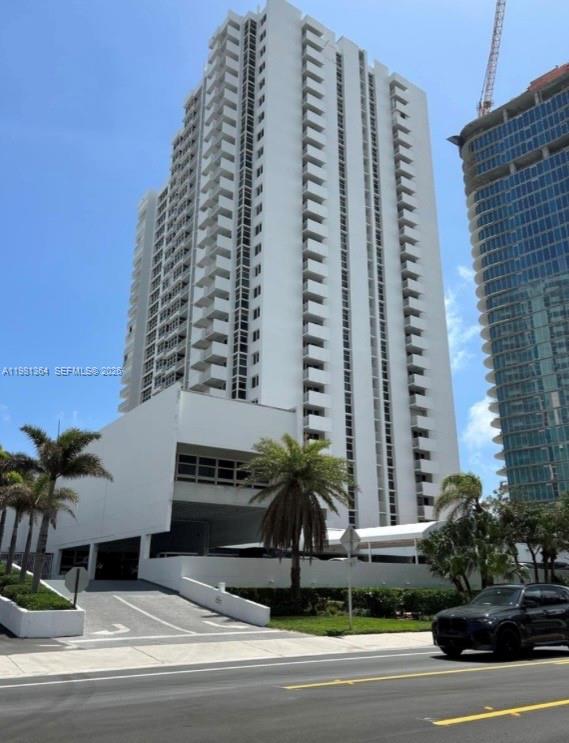 A tall white residential high-rise building stands next to a modern glass skyscraper — 1370 S Ocean Blvd # 1506, Pompano Beach FL 33062, POMPANO BEACH, FL