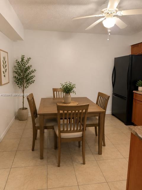 A dining area features a wooden table with four chairs, a potted plant, and ceiling fan — 356 SW 2nd Pl # 3, Pompano Beach FL 33060, POMPANO BEACH, FL