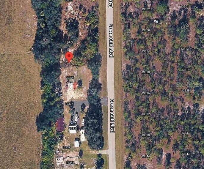 This aerial map view shows a residential street with numbered lots and a red pin — 13315 GREEN GULF BOULEVARD, PUNTA GORDA, FL