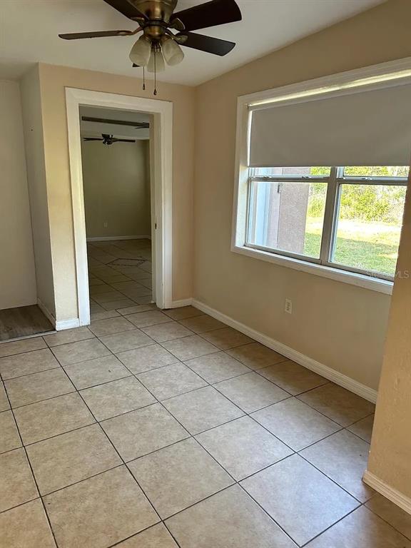 A room with beige tile flooring, a ceiling fan, and a window with a shade — 108 EDGEWATER DRIVE, WINTER HAVEN, FL