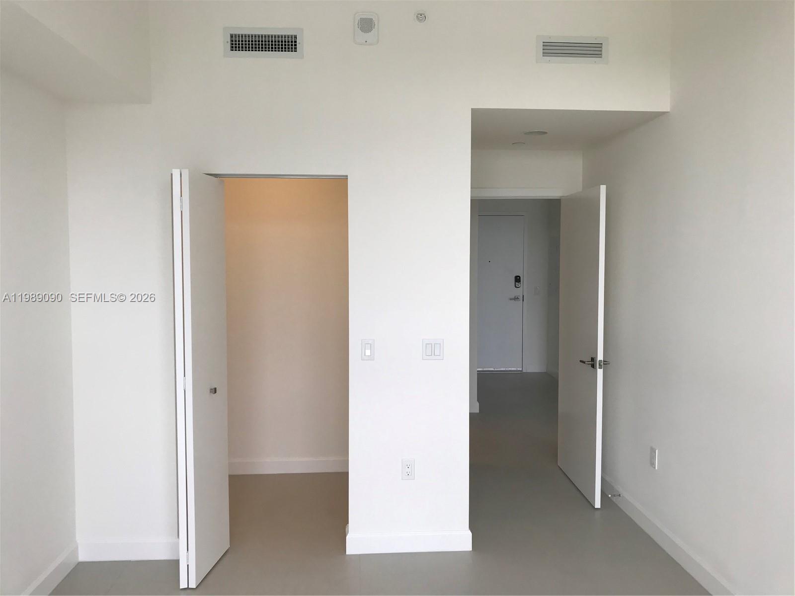 An interior view shows a closet door and an open doorway leading to an entryway — 5350 NW 84th Ave # 1814, Doral FL 33166, DORAL, FL