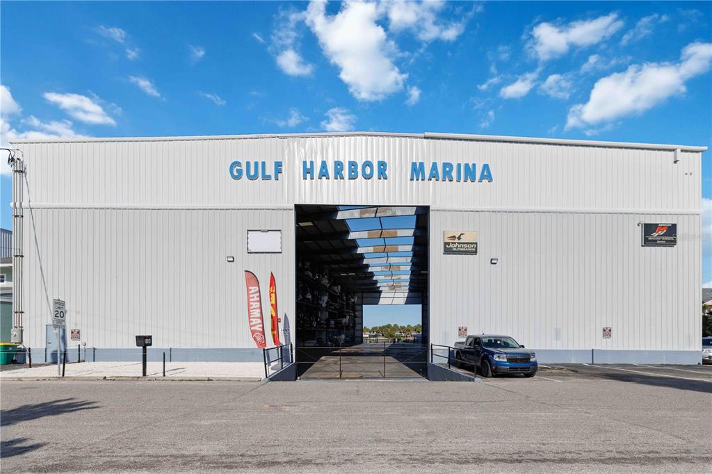 The exterior of the Gulf Harbor Marina building features a large open bay entrance — 100 CIRCUIT ROAD UNIT N11, NOKOMIS, FL