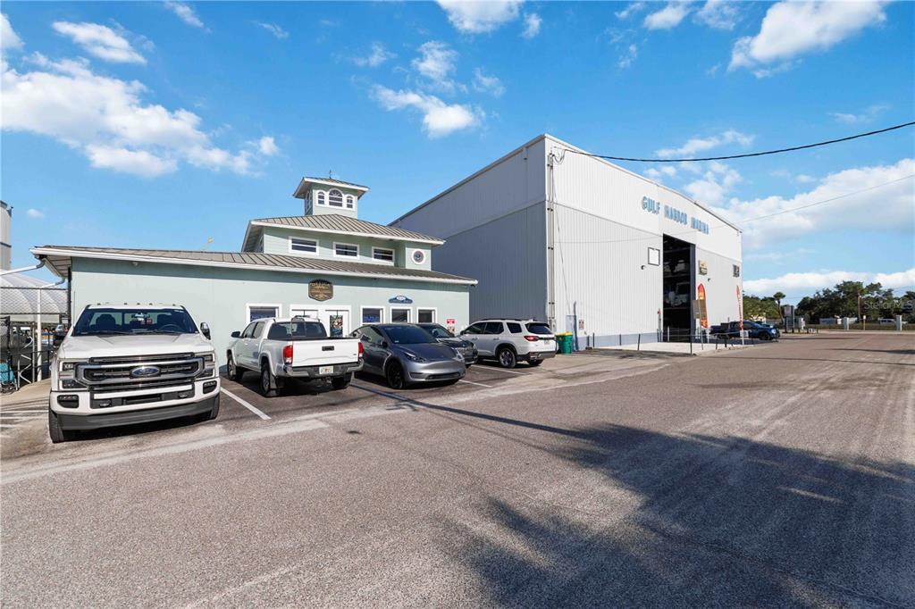 A light green building with a cupola stands next to a large metal warehouse — 100 CIRCUIT ROAD UNIT N11, NOKOMIS, FL