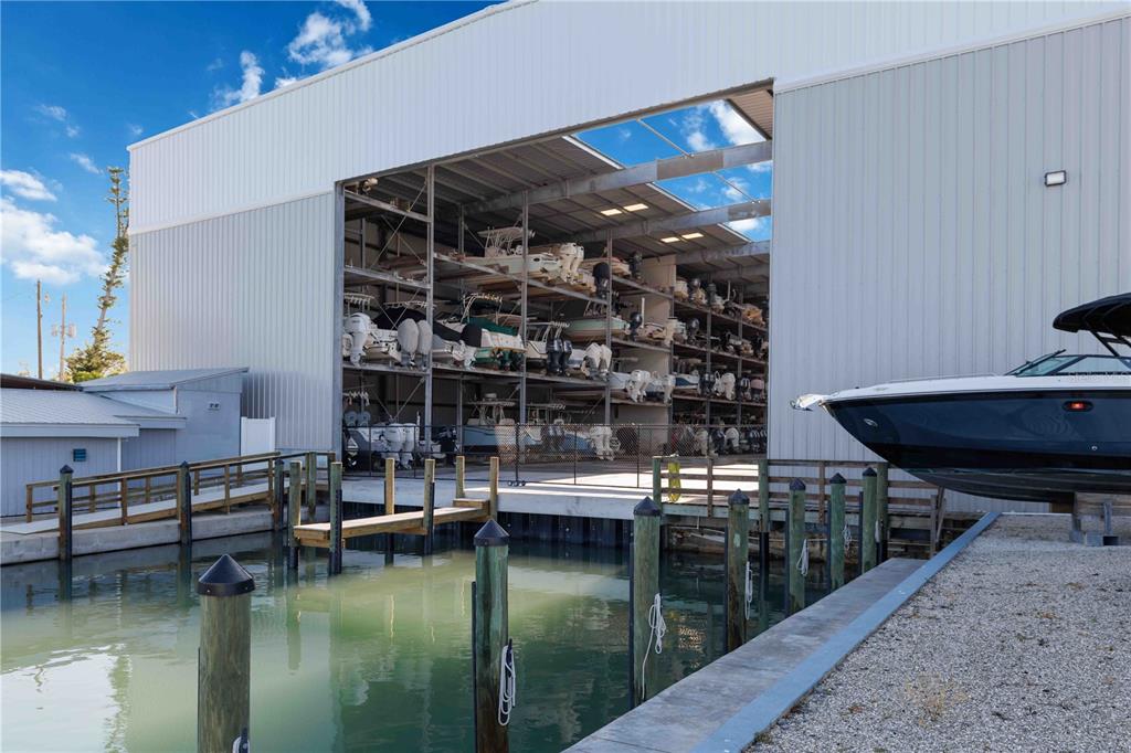 A multi-level indoor boat storage facility sits adjacent to a canal with wooden pilings — 100 CIRCUIT ROAD UNIT N11, NOKOMIS, FL