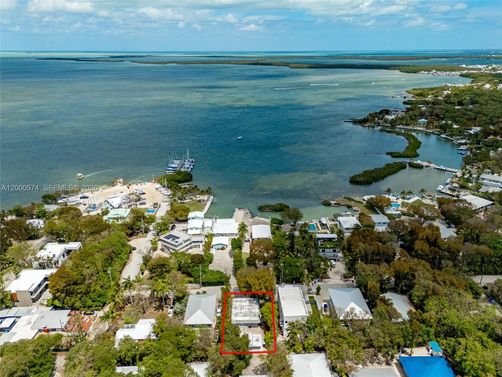 An aerial view shows a house outlined in red near a coastal bay — 367 Buttonwood Shores Dr, Key Largo FL 33037, KEY LARGO, FL