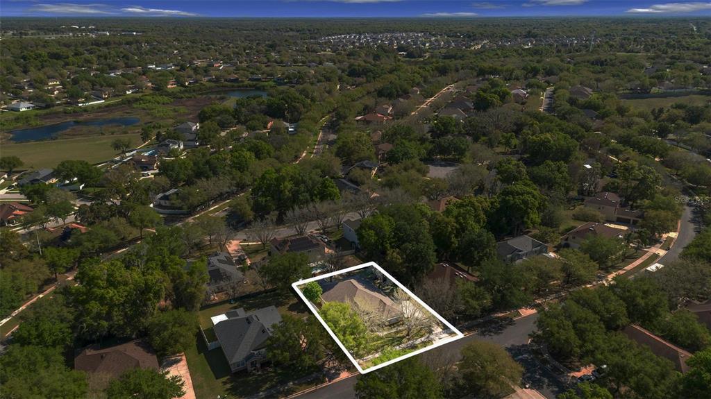 An aerial view shows a single-family home outlined in white within a suburban neighborhood — 2613 BREEZY MEADOW ROAD, APOPKA, FL