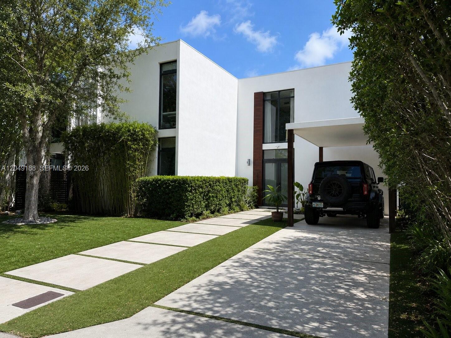 A modern two-story white house with a flat roof, carport, and a paved driveway — 8631 Arboretum Ln, Miami FL 33138, MIAMI, FL