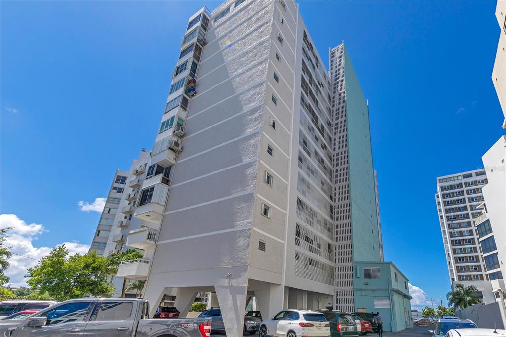 A tall, multi-story apartment building with a light-colored facade and a blue-green vertical accent wall — 14 CALLE MARSEILLES, SAN JUAN, PR