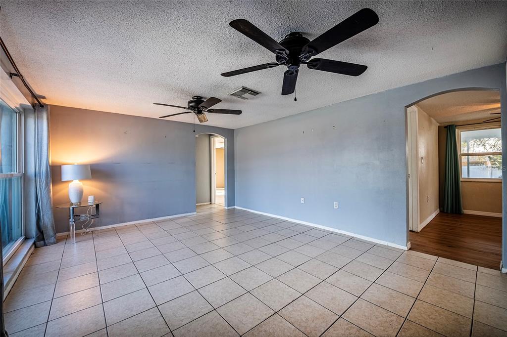 A light blue single-story house features a white garage door and a front entryway — 9720 GRAY FOX LANE, PORT RICHEY, FL