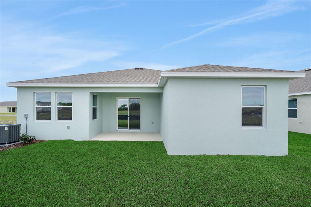 An entryway features white walls, light wood-look tile flooring, and a white front door — 7083 LANIER FALLS ROAD, DELAND, FL