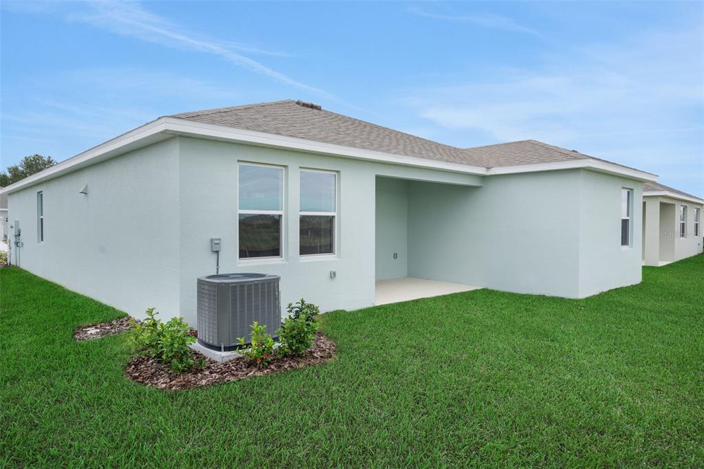 A hallway with a closet, a bathroom with a tub, and a carpeted bedroom doorway — 7083 LANIER FALLS ROAD, DELAND, FL