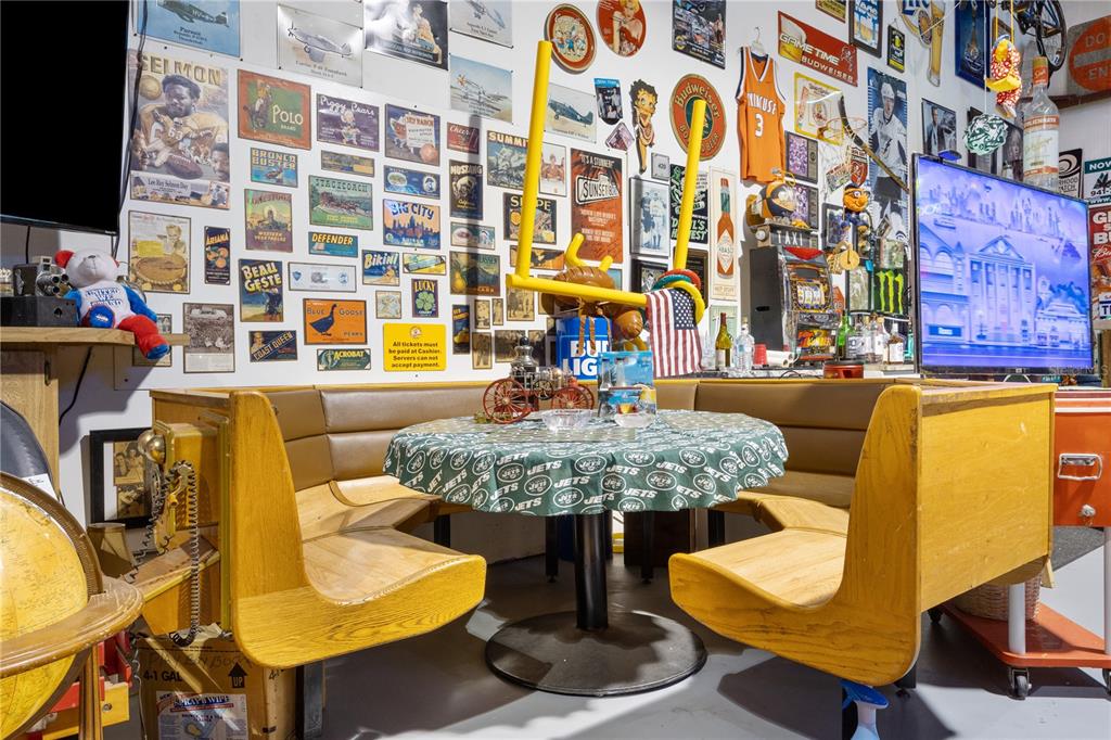 A room features a booth seating area with a Jets-themed table and wall decor — 1090 KNIGHTS TRAIL ROAD UNIT 10, NOKOMIS, FL