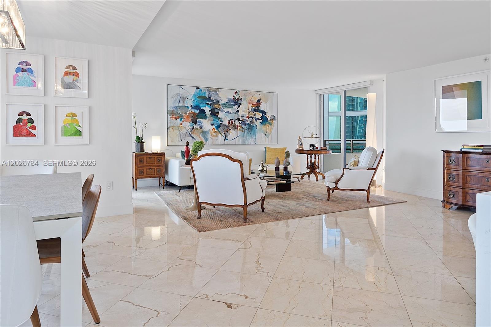 A bright living room features white walls, marble flooring, a large abstract painting, and furniture — 151 SE 15th Rd # 601, Miami FL 33129, MIAMI, FL