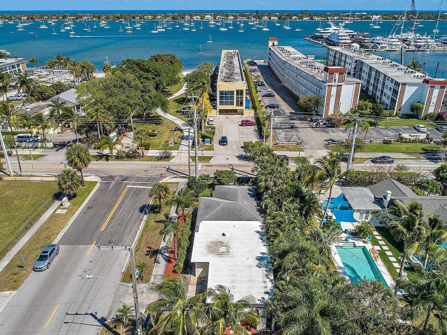An aerial view shows a residential property with a pool near a coastal waterway — 400 45th Street, West Palm Beach FL 33407, WEST PALM BEACH, FL