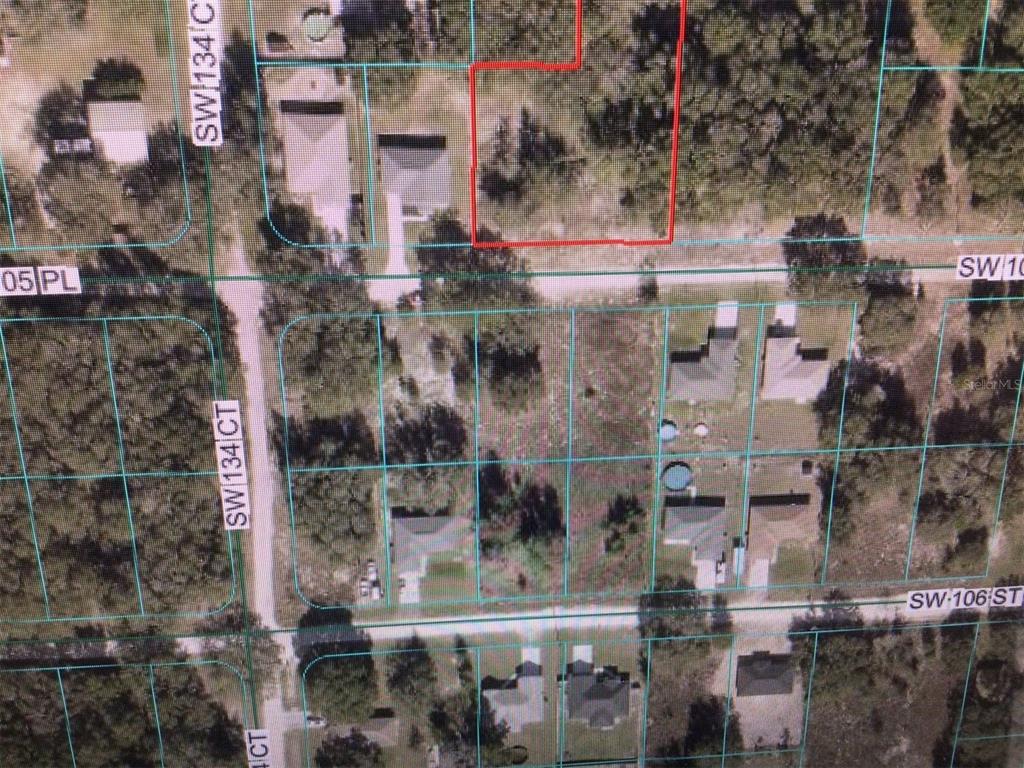 This is an aerial map showing a vacant residential lot outlined in red — 0 SW 105 PLACE, DUNNELLON, FL