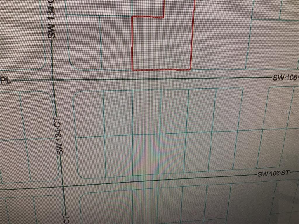 This is a map showing a property boundary outlined in red on a residential street grid — 0 SW 105 PLACE, DUNNELLON, FL