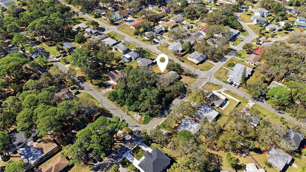 An aerial view shows a wooded residential lot marked by a white map pin — 7214 OELSNER STREET, NEW PORT RICHEY, FL