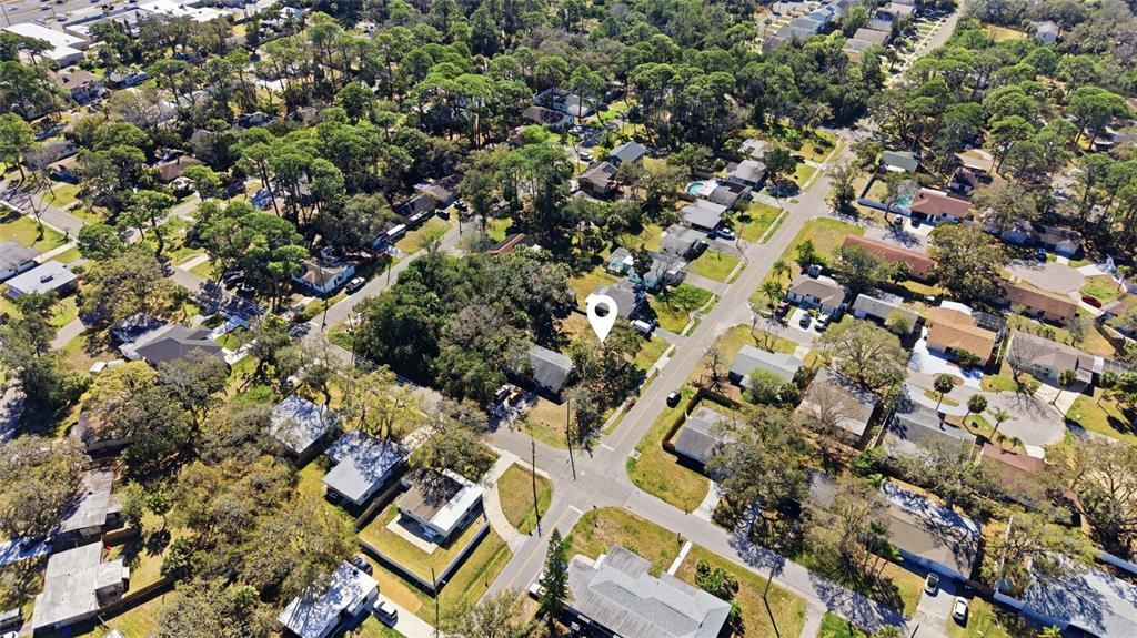 An aerial view shows a residential neighborhood with houses, trees, and intersecting streets — 7214 OELSNER STREET, NEW PORT RICHEY, FL