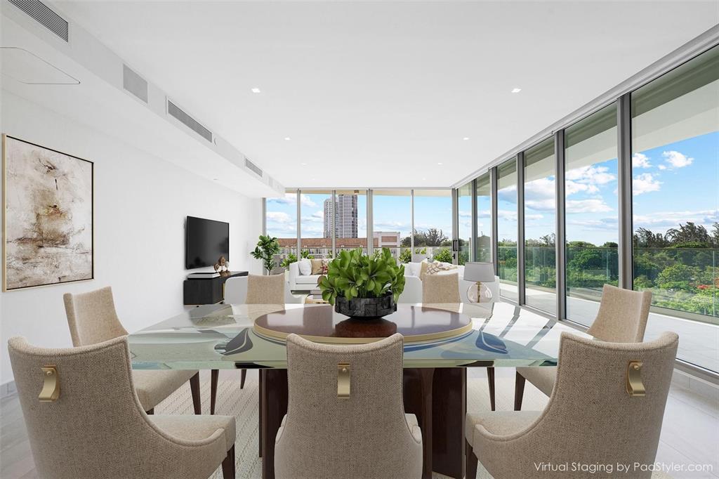 This is a virtually staged dining room with a glass table, beige chairs, and floor-to-ceiling windows — 540 DE LA CONSTITUCION AVENUE UNIT 701, SAN JUAN, PR