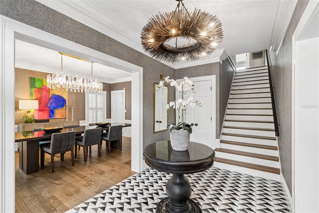 A foyer with a patterned tile floor, a round pedestal table, and a staircase — 3313 W MULLEN AVENUE, TAMPA, FL